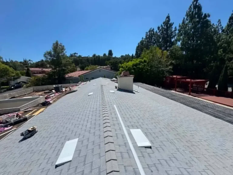 New gray asphalt shingles and ridge vent on a finished roof