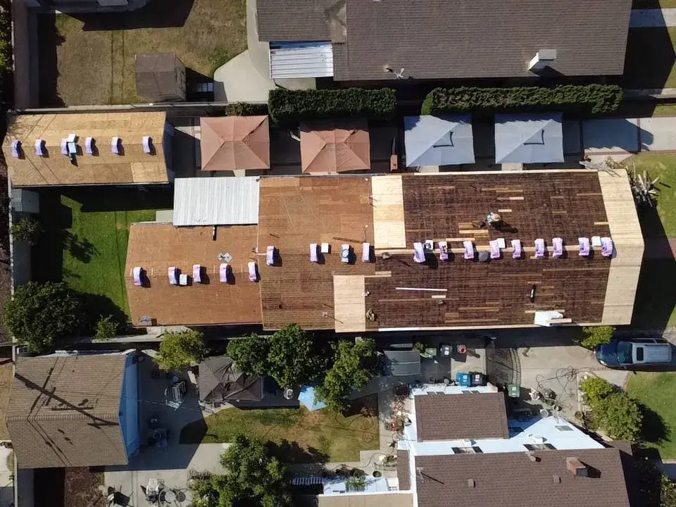 Aerial view of a roof deck with new plywood patches during a re-roof