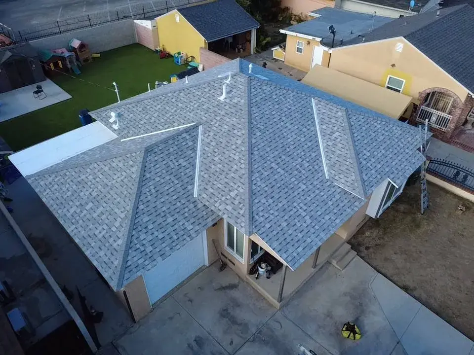 Aerial view of a new blue-gray shingle roof on a single-story home