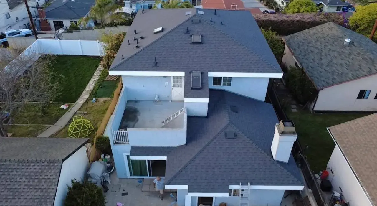 Aerial view of a gray shingle roof on a two-story house