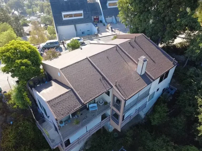 Aerial view of a multi-level home with a brown tile roof