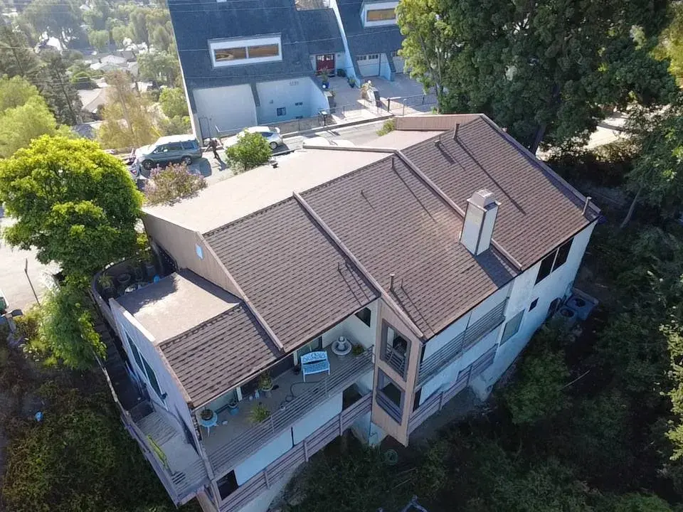 Aerial view of a multi-level home with a brown tile roof